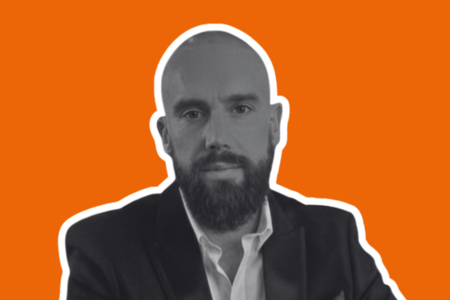 Headshot of Jim Bennett on orange background