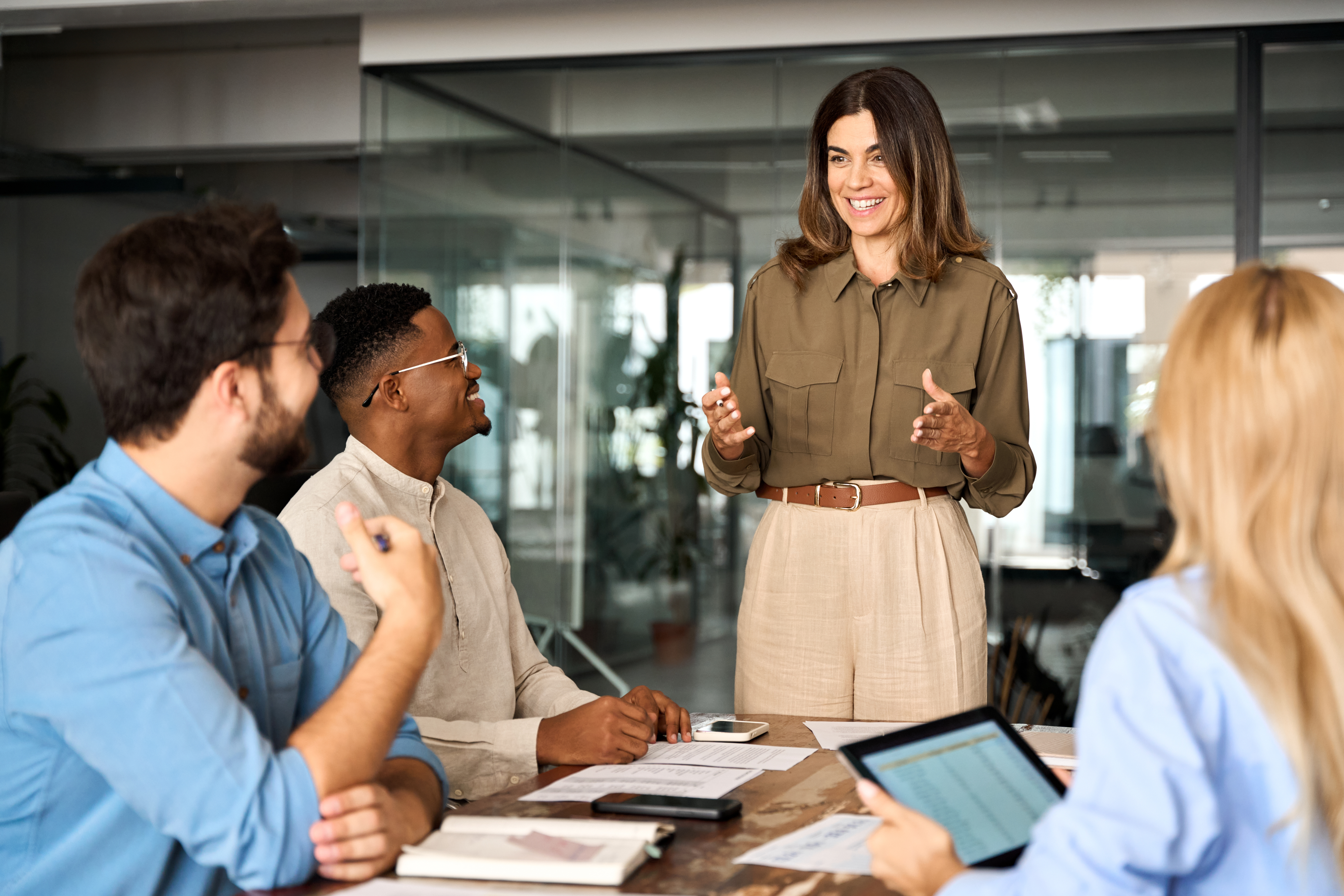 Woman talking to coworkers in office