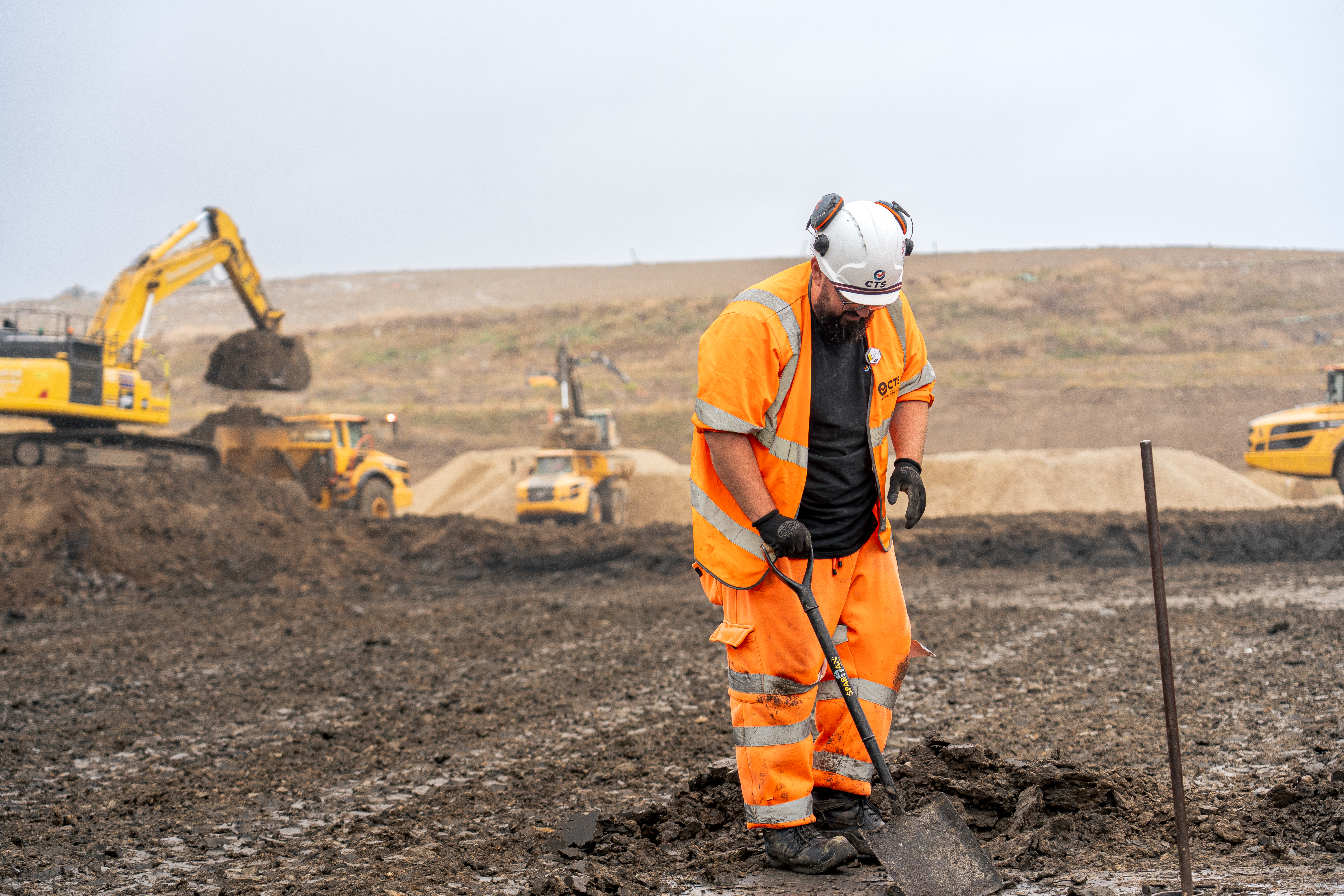 CTS Worker on site with shovel, wearing hi vis CTS uniform
