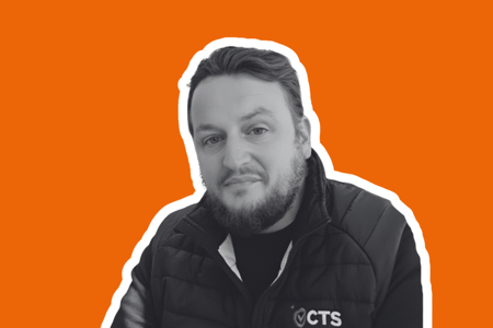 Headshot of Lee Morris on orange background