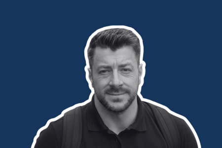 Headshot of Matt Mills on blue background